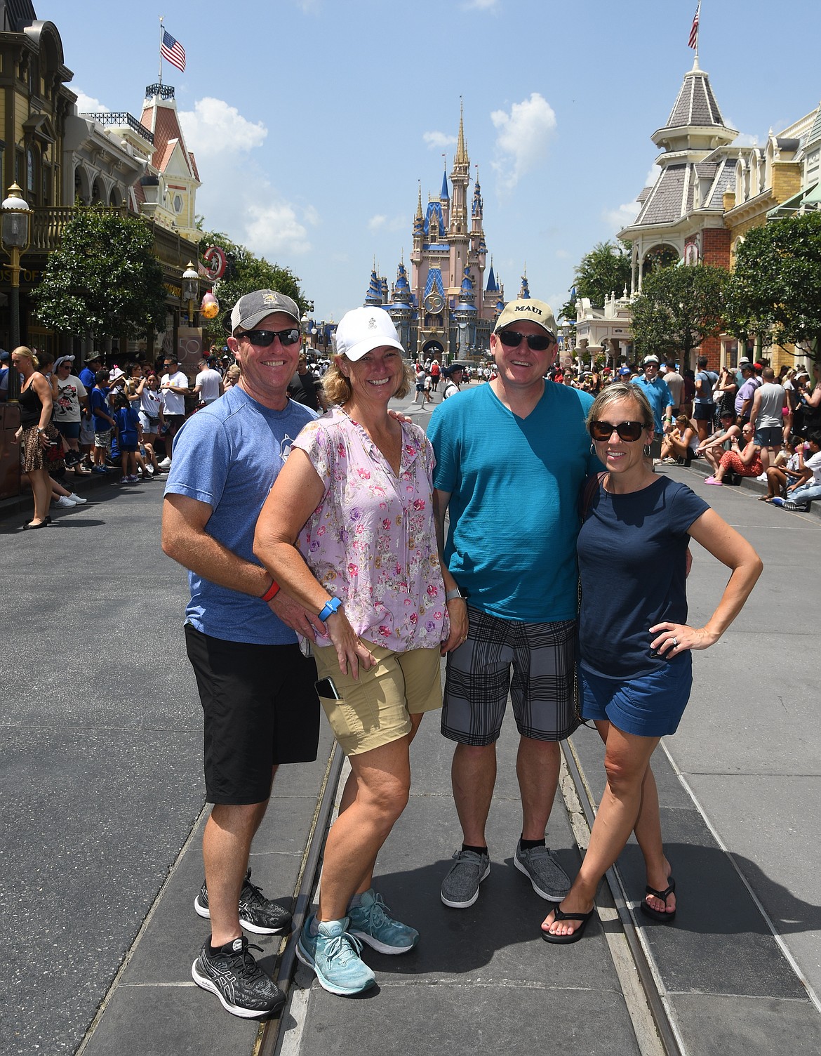 From left, Andy and Lisa Peterson and Scott and Tara Ovinek on Disneyworld’s Main Street, USA.