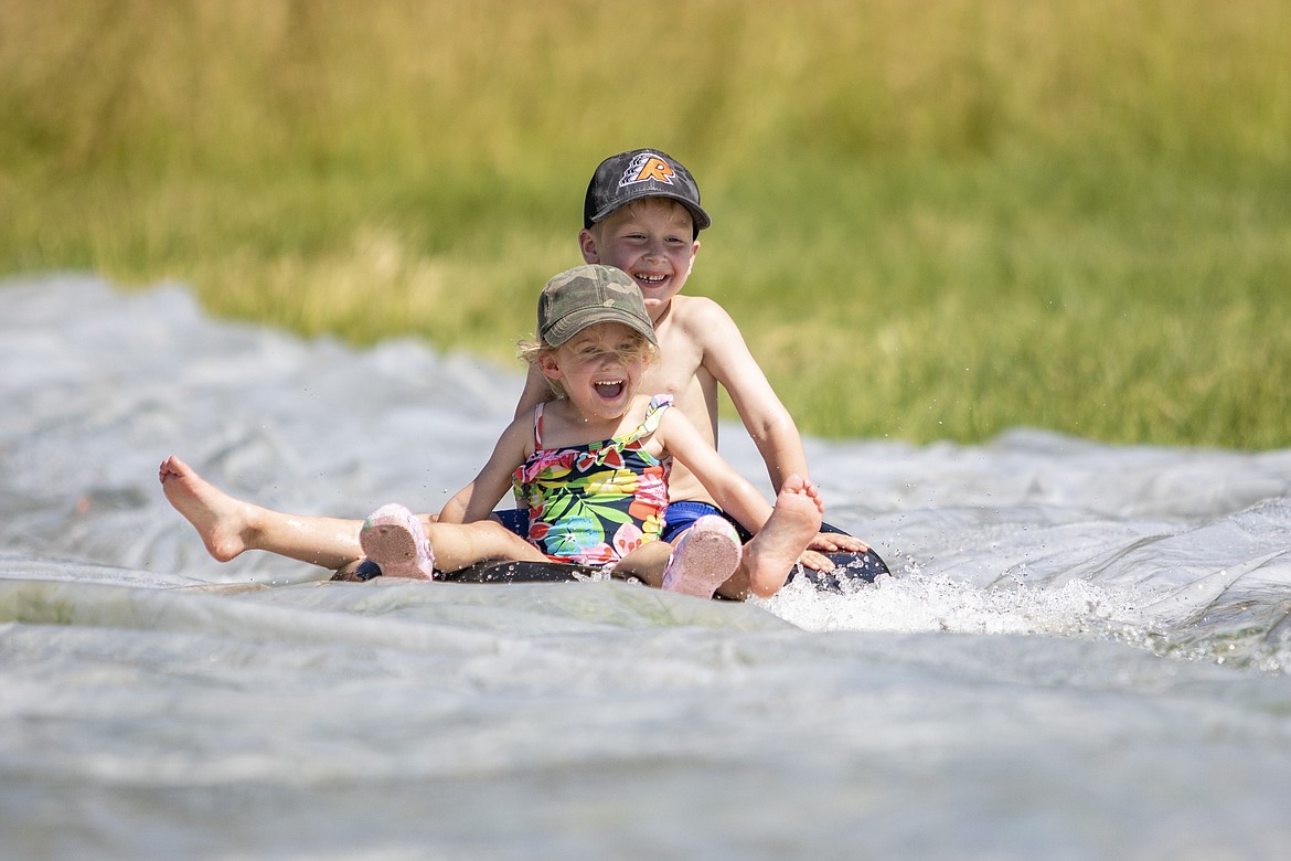 Kids enjoy the homemade slip and slide course. (Rob Zolman/Lake County Leader)