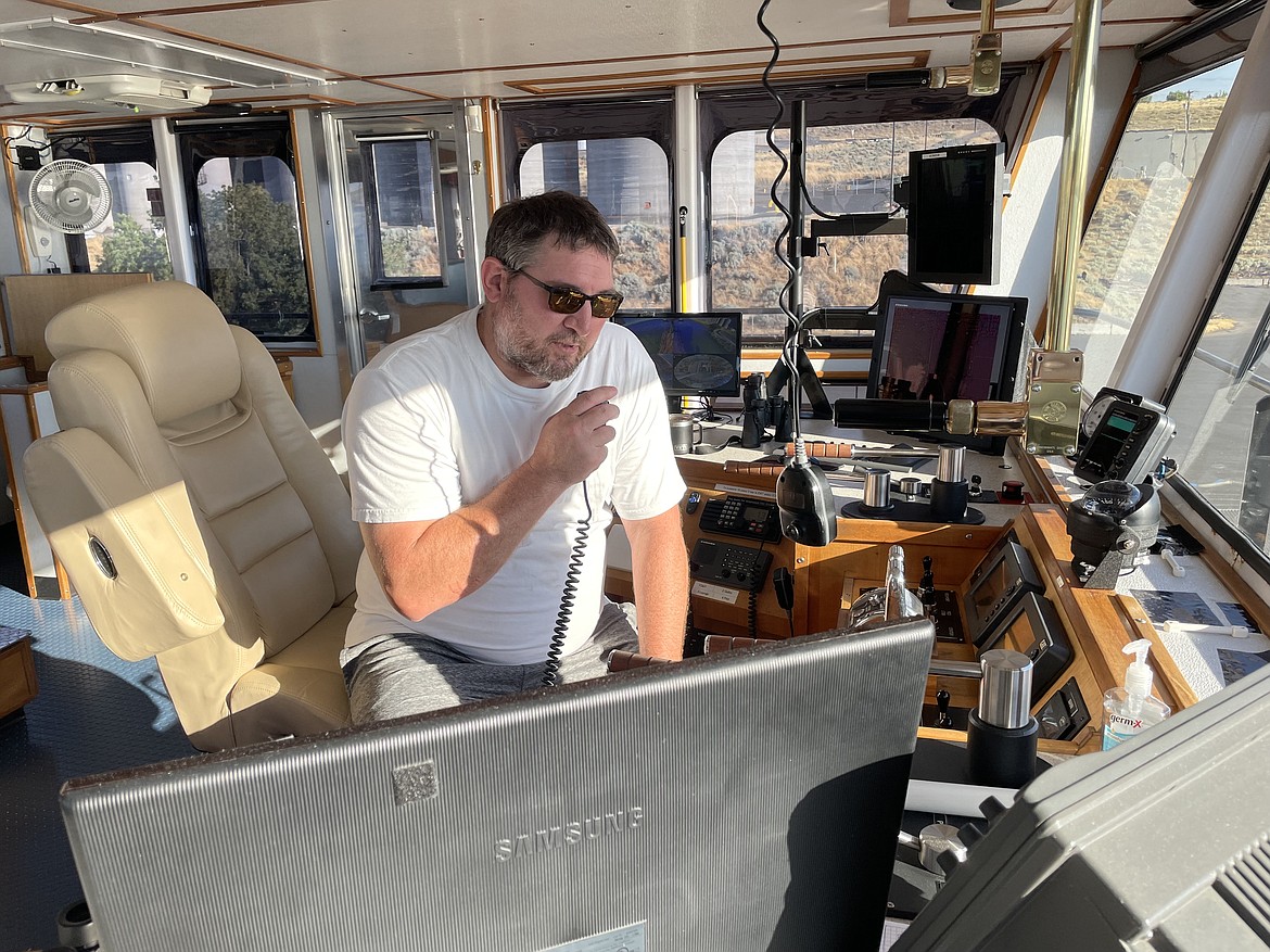 Troy Moore, a tugboat pilot and captain with Shaver Transportation, in the wheelhouse of the tugboat Lincoln as he hauls 13,000 tons of wheat down the Snake and Columbia rivers last week.