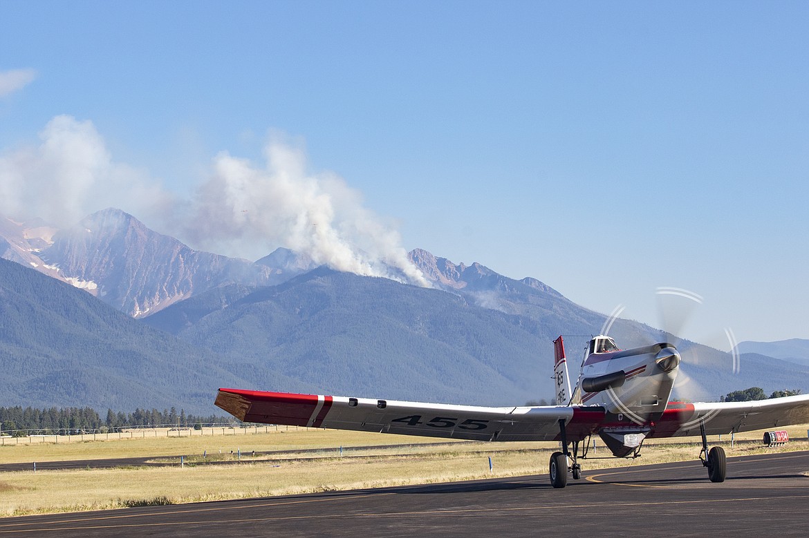 The Redhorn Fire sends up smoke on the Mission Mountains north of St. Ignatius. (Rob Zolman/Lake County Leader)