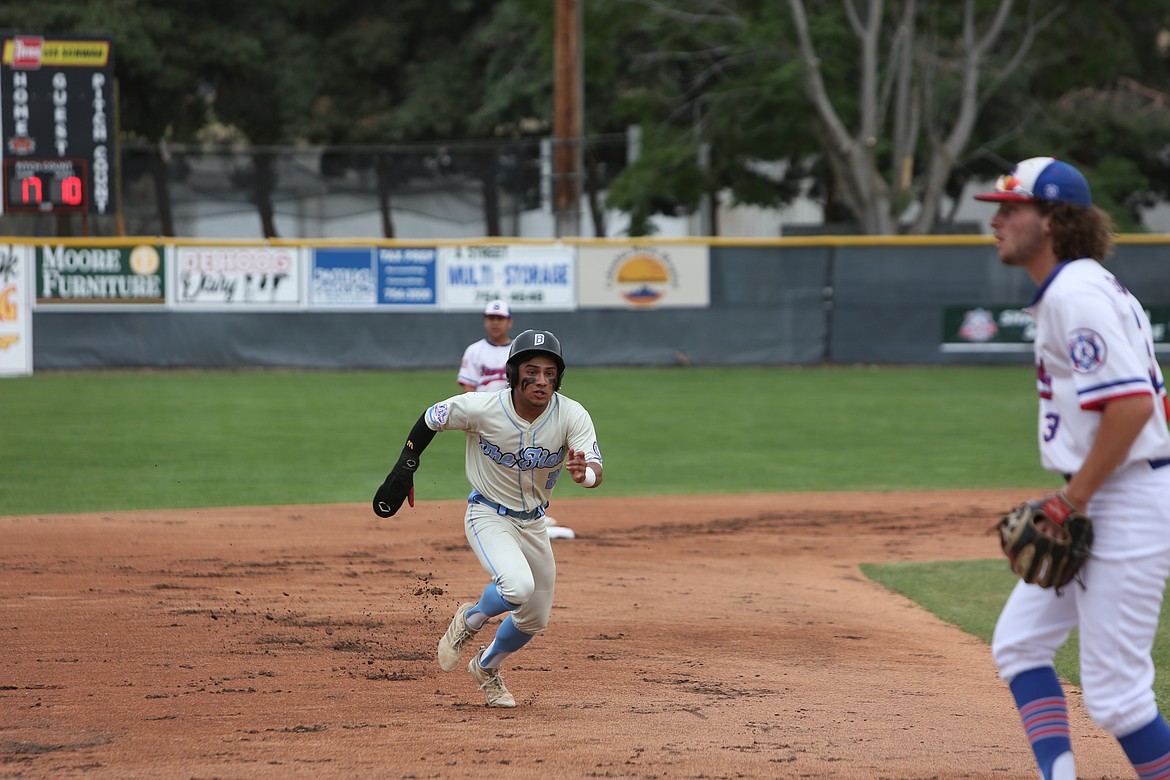 Northwest Bakersfield’s Luis Fuentes prepares to slide into third base before scoring in the next at-bat.