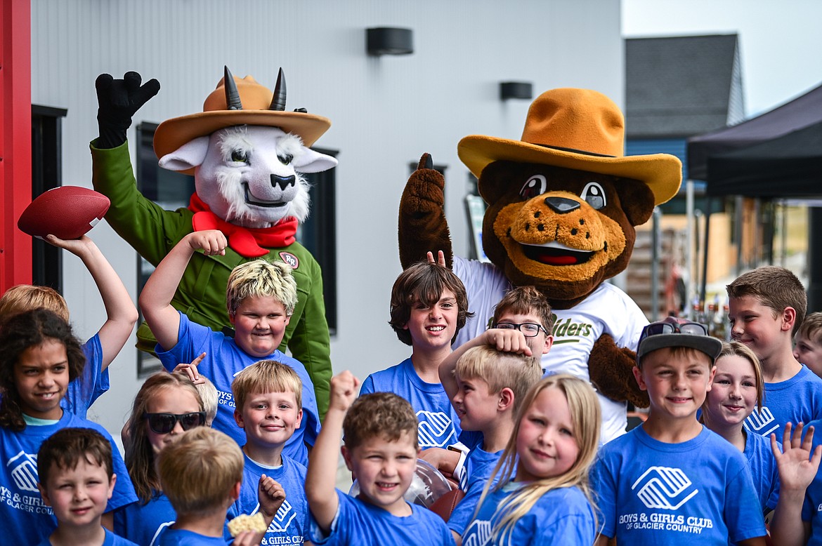 Children from the Boys & Girls Club of Glacier Country have their photo taken with Glacier Range Rider mascots Cliff and Huck at the World Gym Cares Fair on Wednesday, Aug. 10. Proceeds from the fair benefitted the Boys & Girls Club. (Casey Kreider/Daily Inter Lake)