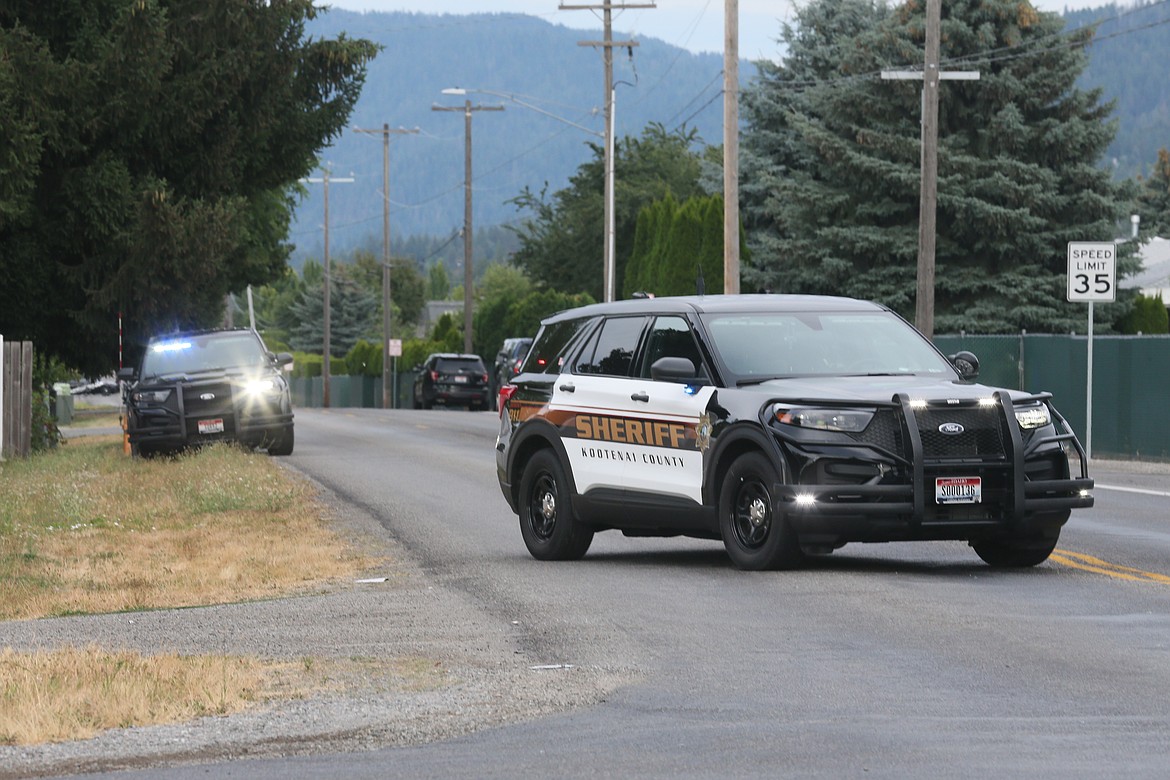 A Kootenai County Sheriff's Office vehicle blocks Honeysuckle Road in Hayden Wednesday as deputies respond to a suspected domestic violence situation at a home on Neufeld Road.