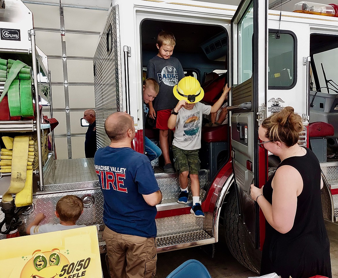 PVFD volunteer shows the new fire truck off to an excited group of kids.