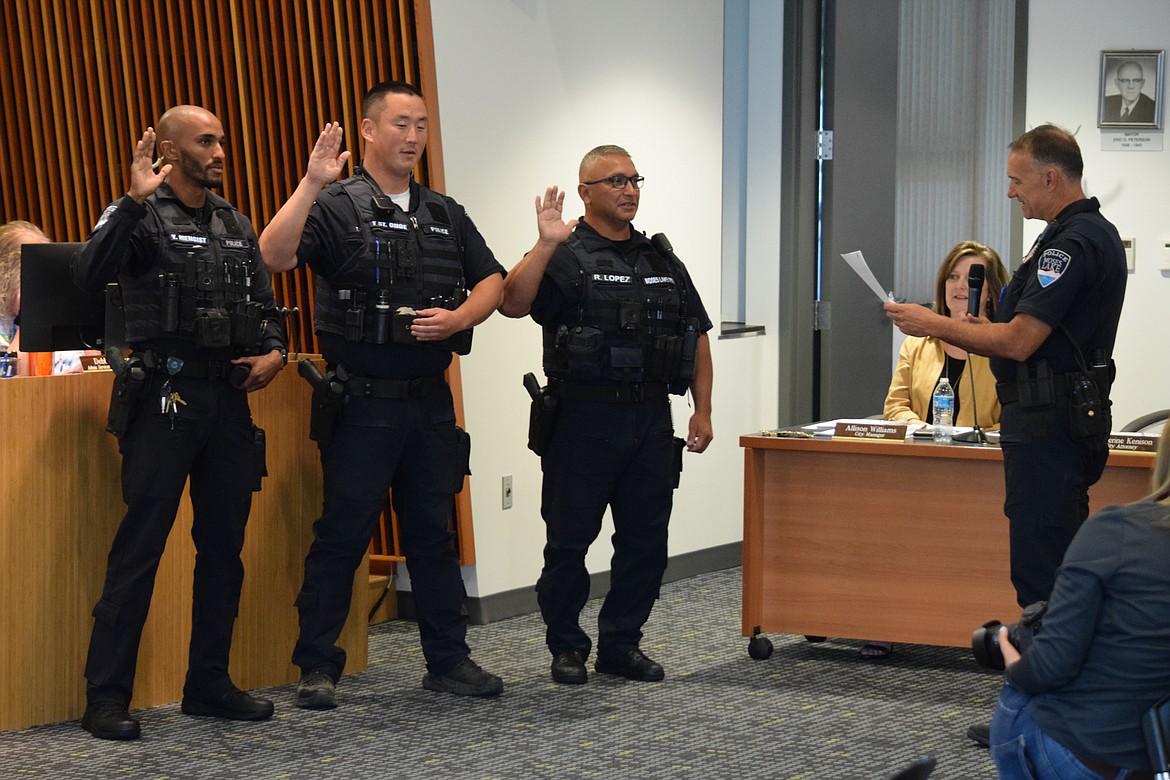 Moses Lake Police Chief Kevin Fuhr (right) swears in new Moses Lake Police Corporals (L-R) Yonan Mengist, Tyler St. Onge and Ray Lopez during a regular meeting of the Moses Lake City Council on Tuesday.