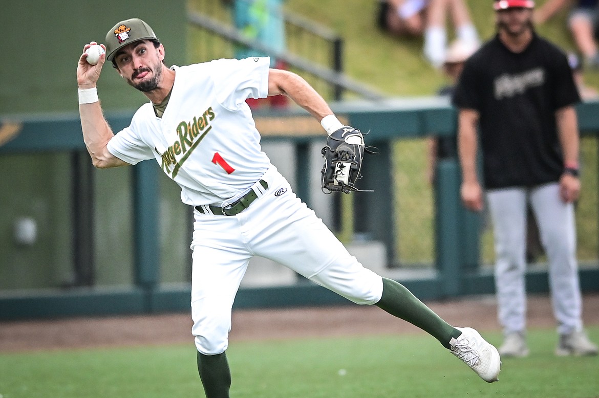 Glacier third baseman Brandt Broussard (1) charges and fires to first after fielding a slow-roller hit by Great Falls' Collin Runge at Flathead Field on Thursday, Aug. 11. Runge beat out the throw for a single. (Casey Kreider/Daily Inter Lake)