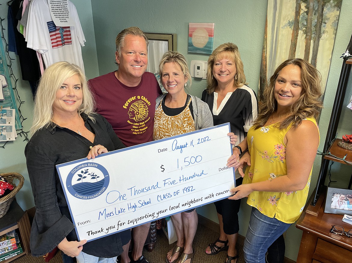 Members of the Moses Lake High School class of 1982 (L-R) Juile Fairbanks, Rich Victor, Cathay Lane and Alice Brooks present a check for $1,500 to Angel Ledesma, executive director of the Columbia Basin Cancer Foundation, Thursday morning in the foundation’s office in Moses Lake.