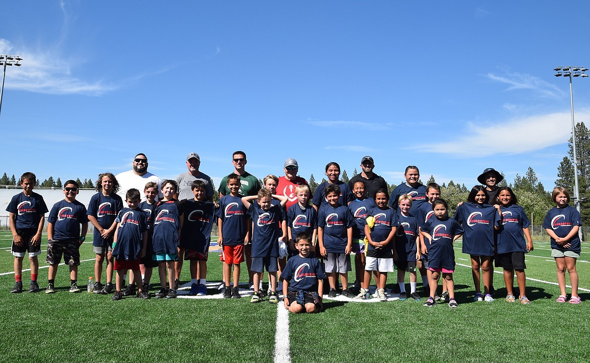 Football campers and their mentors smile for the camera at the Marimn Health Coeur Center.