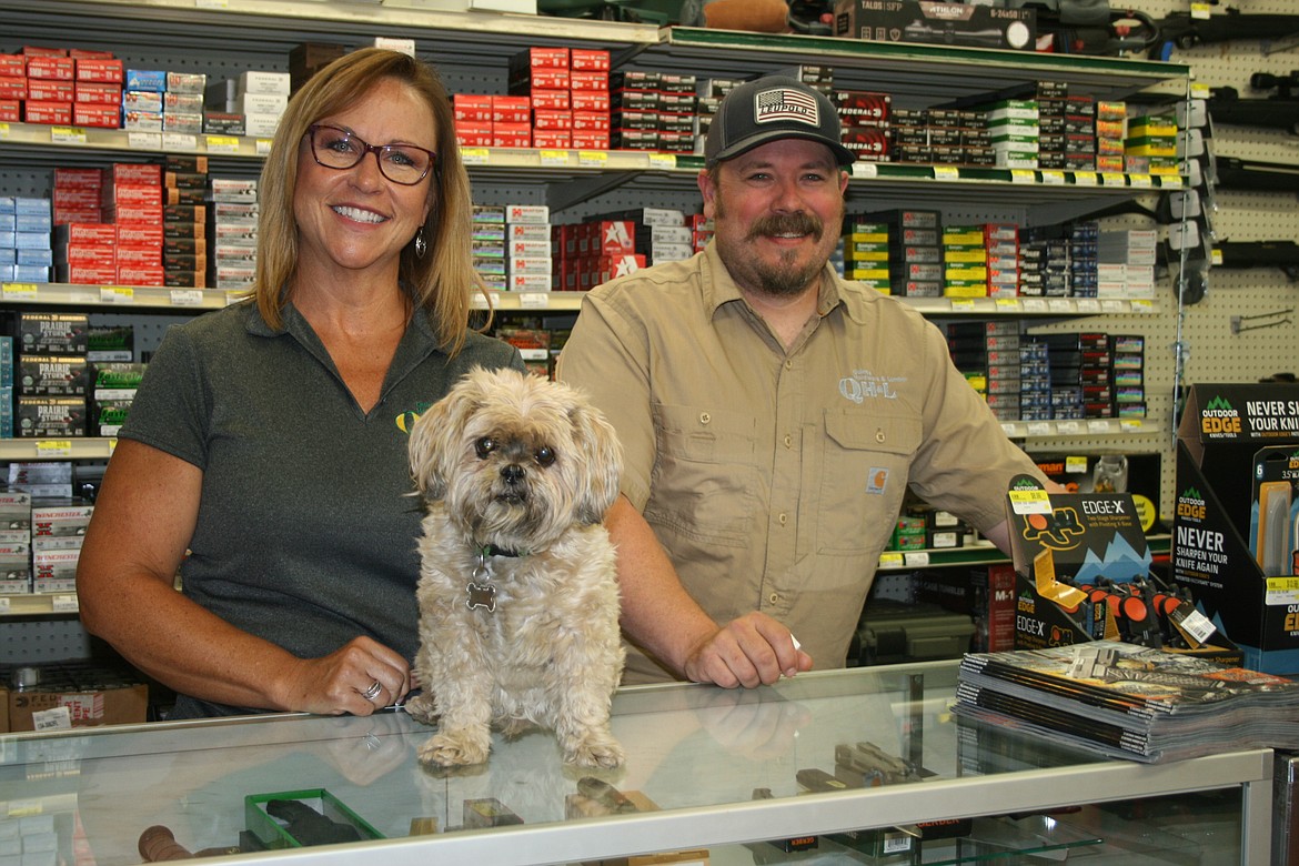 Quincy Hardware and Lumber owner Tina Statner (left), manager Jeremy Sewall (right) and Sophie, the Stetner family dog that’s part of the staff.