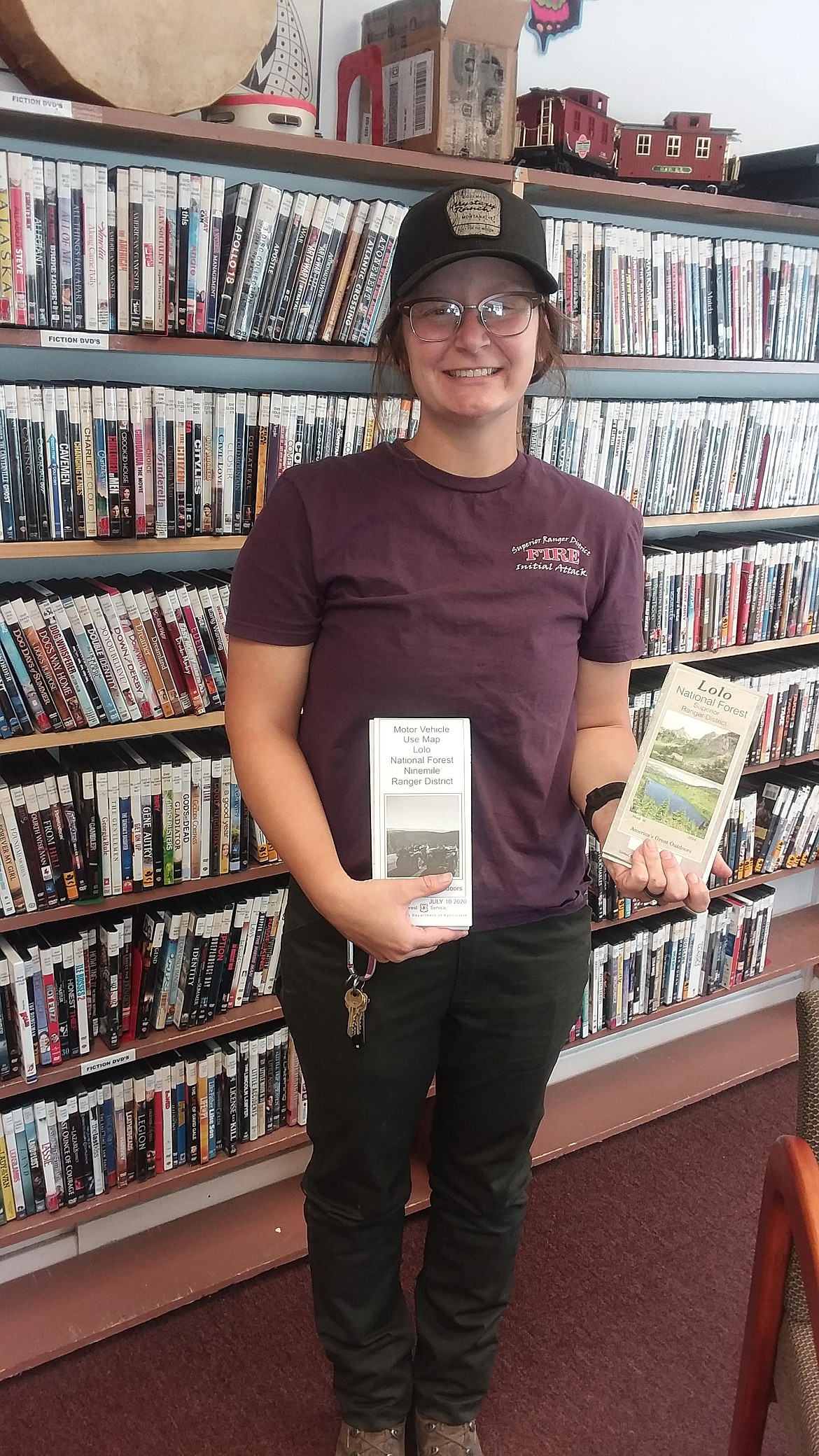 Rachel Ryan with the Superior District of the Lolo National Forest hold the 2 maps available at their office for hikers and campers. Ryan spoke at the Mineral County Library Confab recently. (Monte Turner/Mineral Independent)