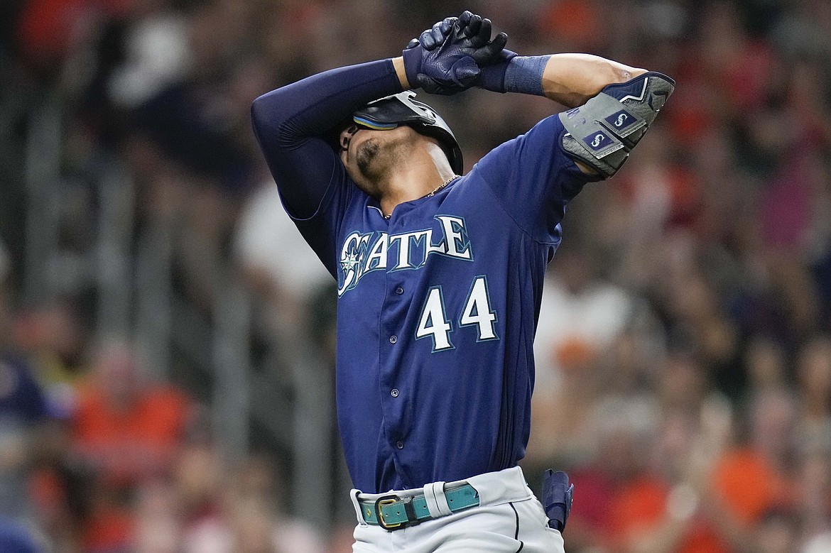 Seattle Mariners' Julio Rodriguez reacts after striking out during the eighth inning of the team's baseball game against the Houston Astros, Saturday, July 30, 2022 in Houston.