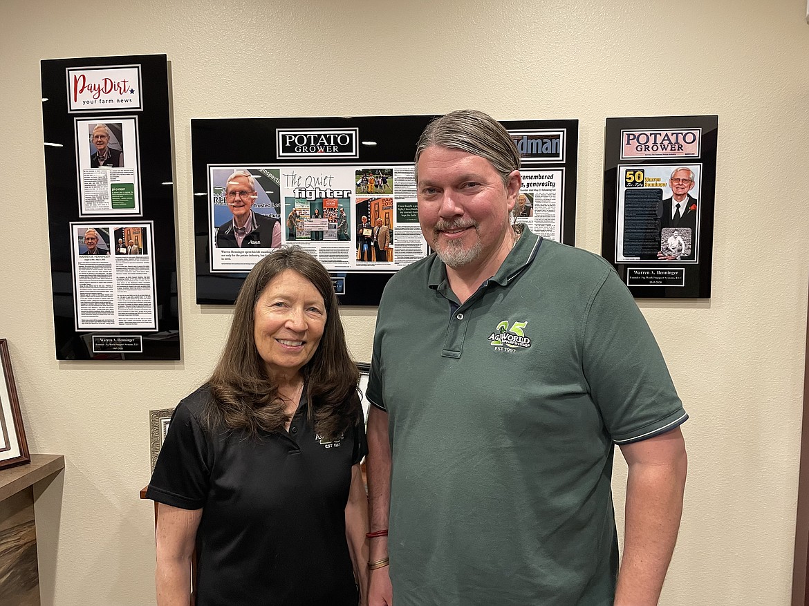Ag World Support Systems owners Judy Henninger and Bryan Henninger in the lobby of their Moses Lake headquarters, in front of the creche honoring the company’s founder, Warren Henninger, who died in 2020.