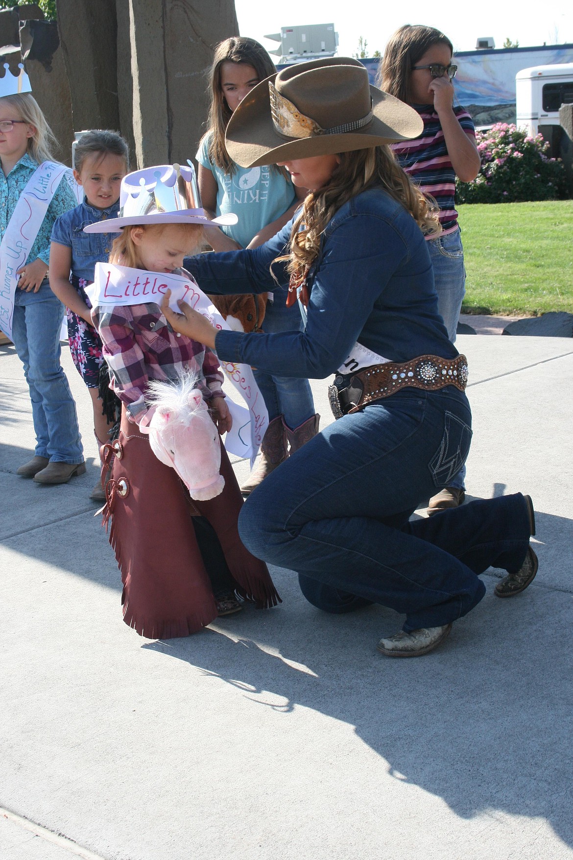 Harper Carey is crowned queen of the Pee Wee Stampede by Miss Moses Lake Roundup Brianna Kin Kade. The children’s games are part of the annual Cowboy Breakfast, the traditional kickoff for the Grant County Fair and Moses Lake Roundup.