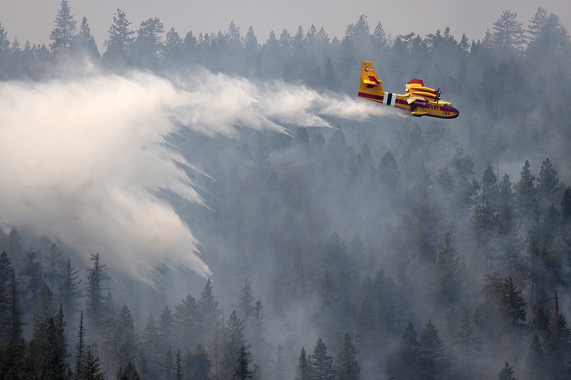 A Bridger Aerospace CL-415EAF super scooper drops water on the Elmo Fire near Black Lake Monday, Aug. 1. (Jeremy Weber/Daily Inter Lake)