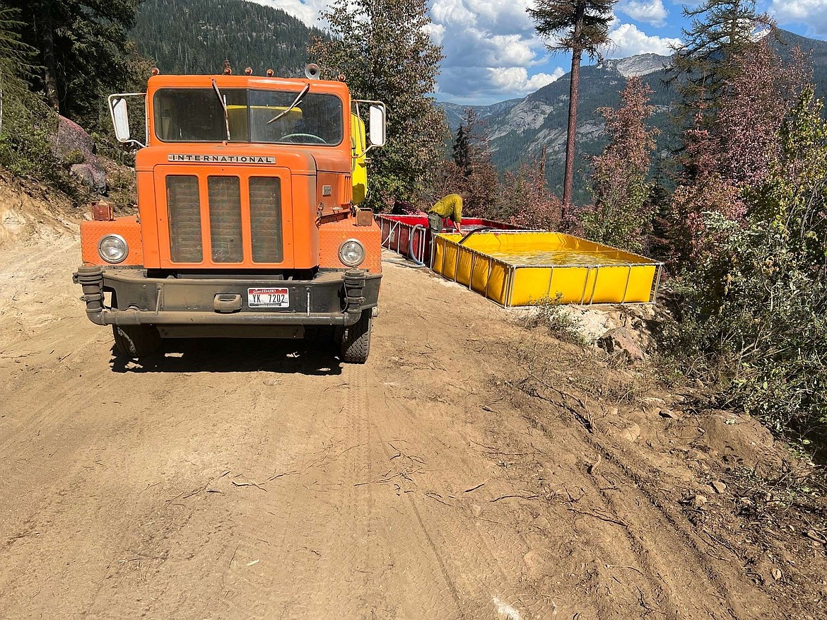 Water tender and water tanks supplying water to fireline