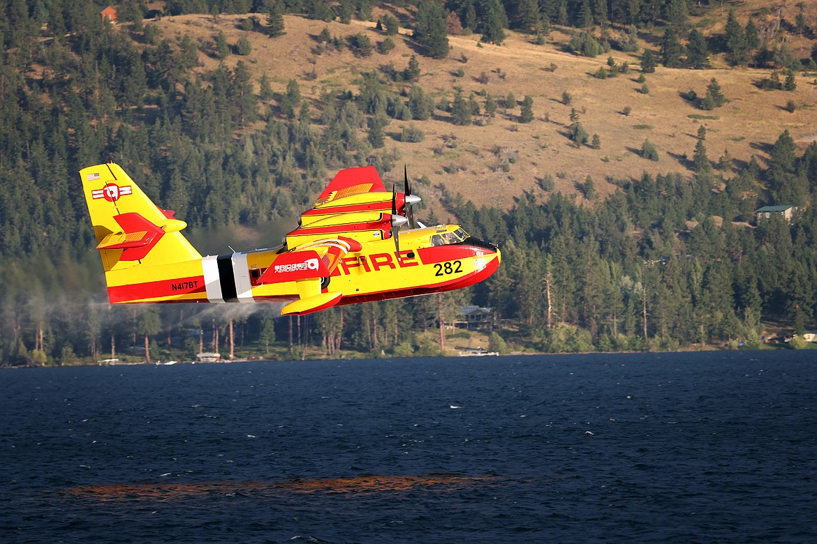 A Bridger Aerospace CL-415EAF super scooper pulls water from Flathead Lake between Elmo and Dayton Aug. 1. (Jeremy Weber/Daily Inter Lake)