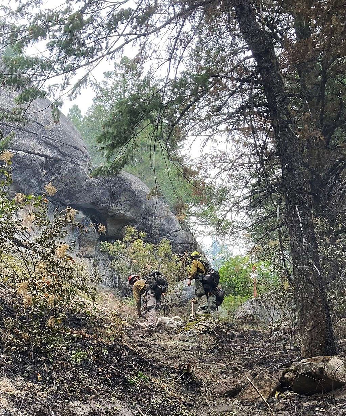 Firefighters tackle steep and rocky terrain as they fight the Lions Roar Fire near Priest Lake.