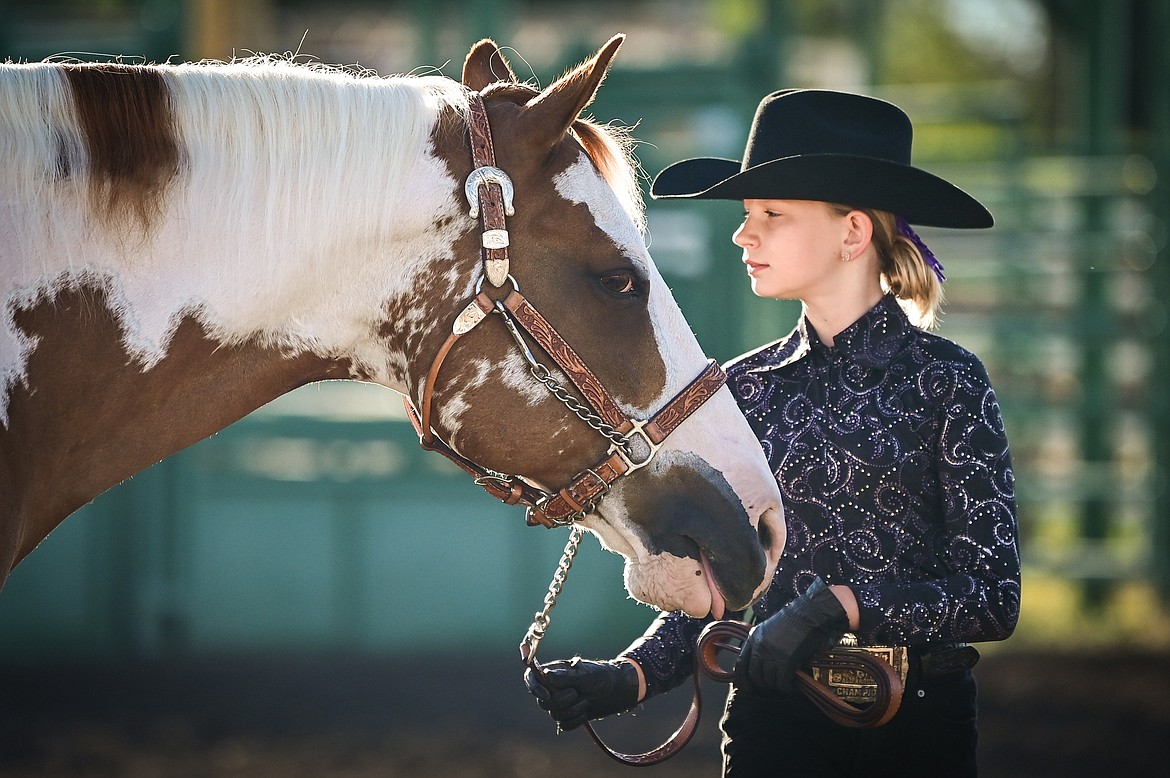 Raya Gronley stands by her horse during junior level showmanship at the 4-H Horse Show at the Northwest Montana Fair on Saturday, Aug. 13. Gronley won grand champion in her division. (Casey Kreider/Daily Inter Lake)
