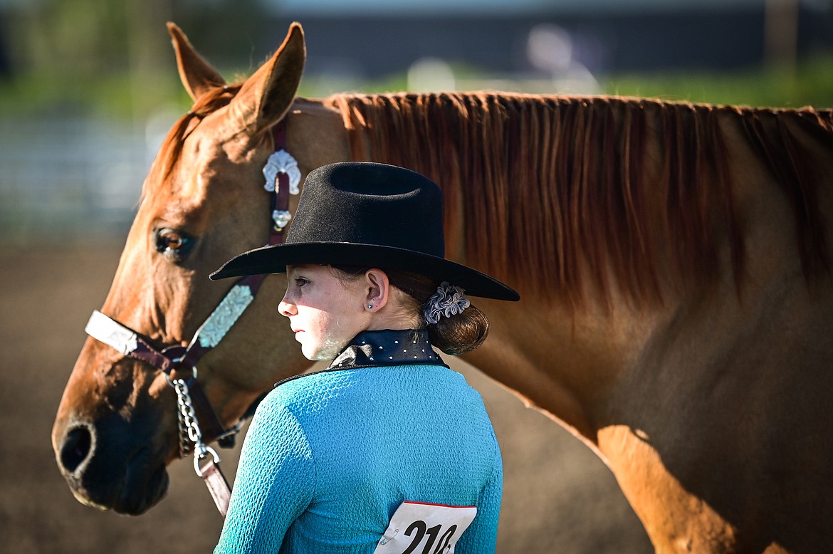Sidni Sorenson stands by her horse during pre-junior level showmanship at the 4-H Horse Show at the Northwest Montana Fair on Saturday, Aug. 13. (Casey Kreider/Daily Inter Lake)