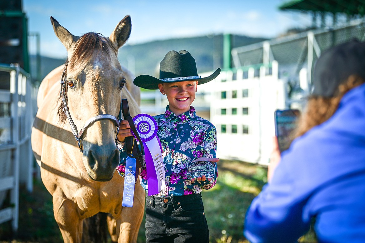 Kylie Boucher poses for a photo after winning grand champion in novice level showmanship at the 4-H Horse Show at the Northwest Montana Fair on Saturday, Aug. 13. (Casey Kreider/Daily Inter Lake)
