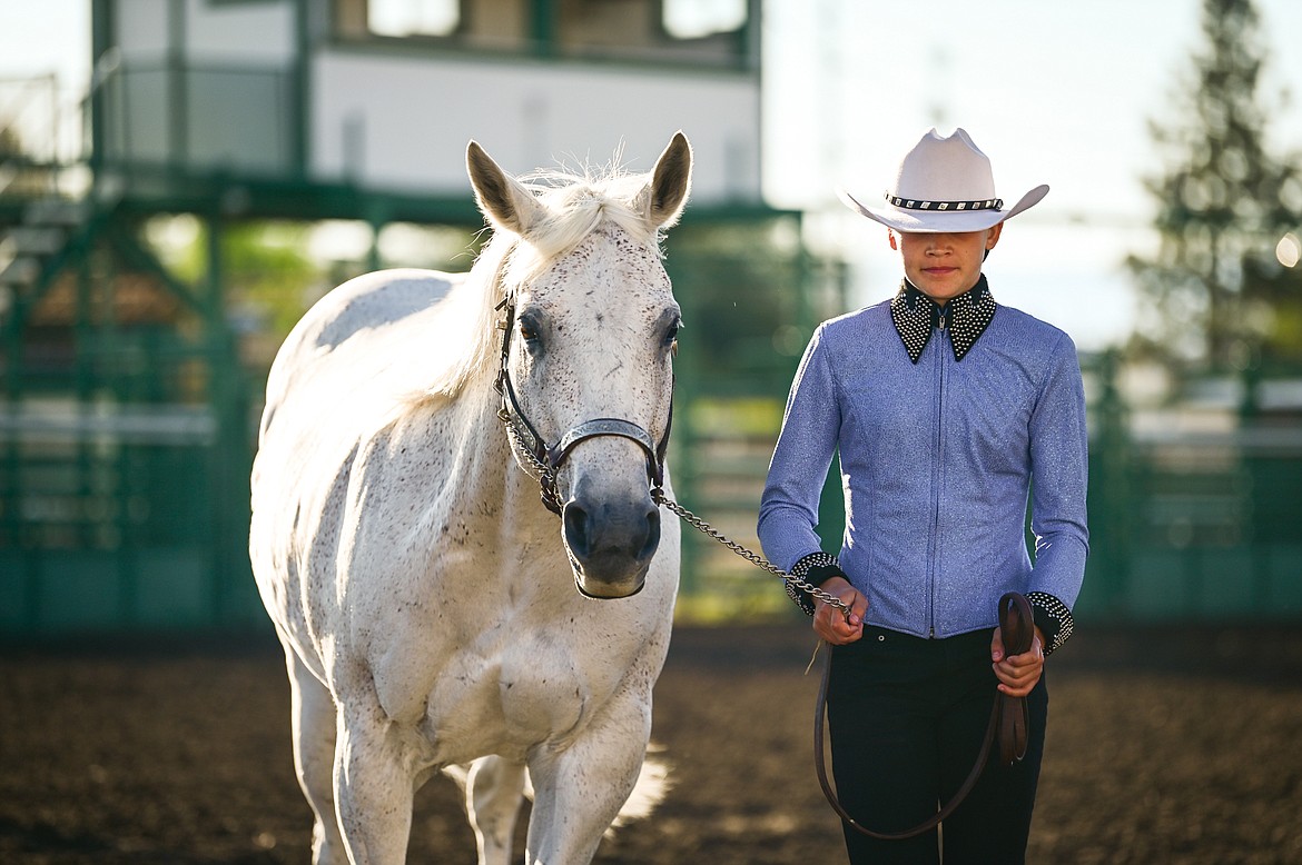 Jessa Morris leads her horse through the pattern during junior level showmanship at the 4-H Horse Show at the Northwest Montana Fair on Saturday, Aug. 13. At right is judge Tyrell Burklund. (Casey Kreider/Daily Inter Lake)