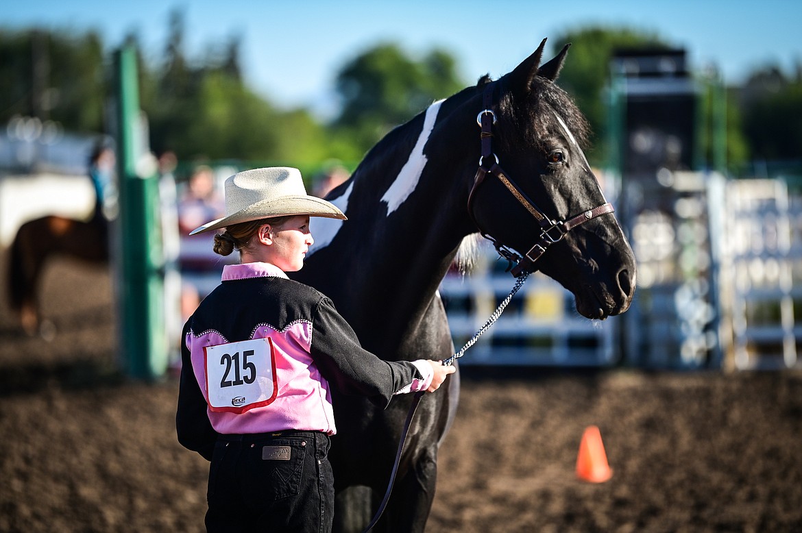 Reagan Roberts stands with her horse during novice level showmanship at the 4-H Horse Show at the Northwest Montana Fair on Saturday, Aug. 13. (Casey Kreider/Daily Inter Lake)
