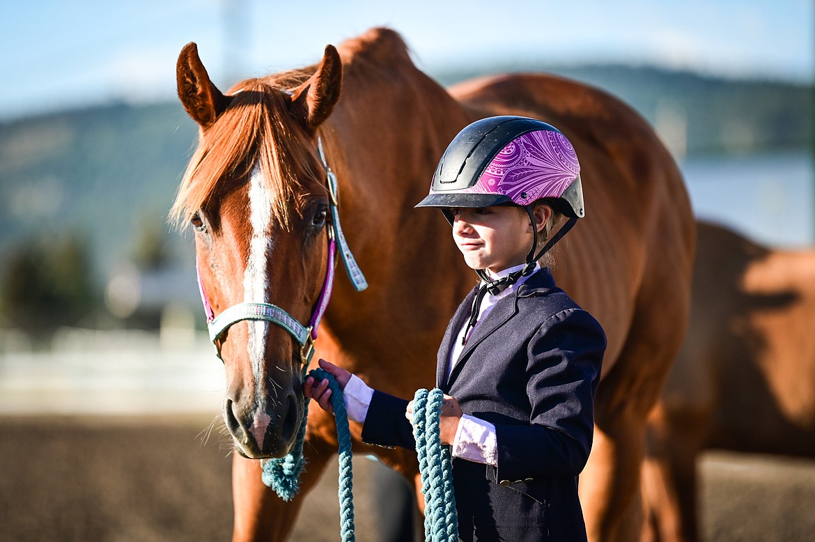 Ava Rohletter stands by her horse during pre-junior level showmanship at the 4-H Horse Show at the Northwest Montana Fair on Saturday, Aug. 13. (Casey Kreider/Daily Inter Lake)