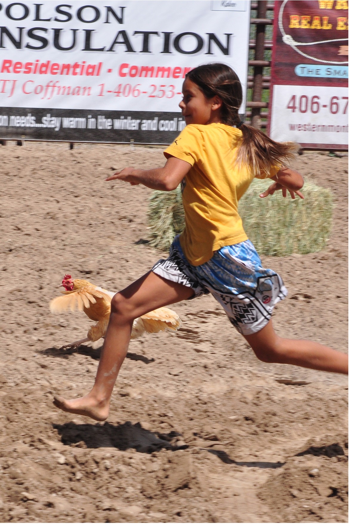 And the chicken wins by a feather. This wasn't actually a race between kids and chickens. The goal was to catch a chicken. (Marla Hall/Lake County Leader)