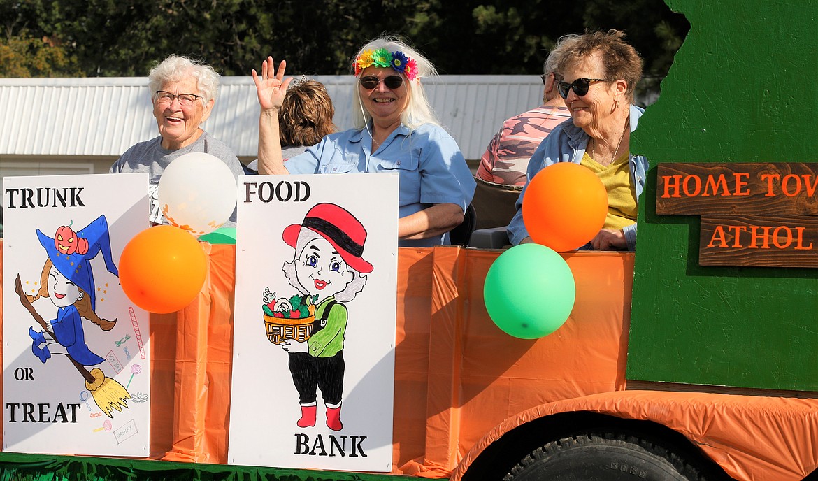 Sheryl McDaniel, left, Jeri Groth, center and Florence Brown with the Spirit Lake Grandmothers' Club wave to the crowd at the Athol Daze Parade.