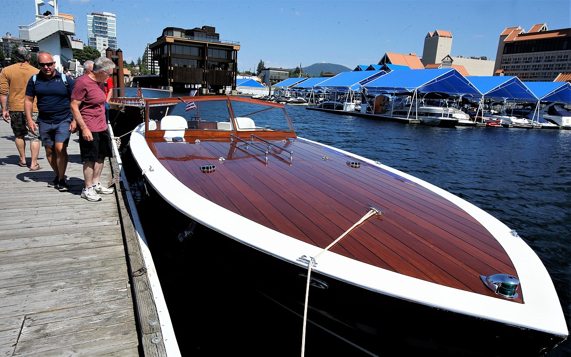 People check out one of the boats in the Coeur d’Alene Antique & Classic Boat Festival on Saturday.