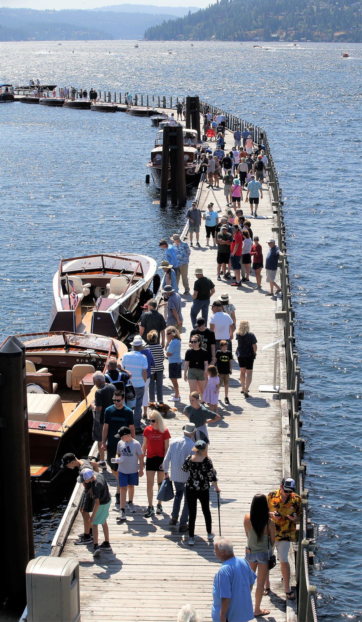 People and boats line the boardwalk for the Coeur d’Alene Antique & Classic Boat Festival on Saturday.