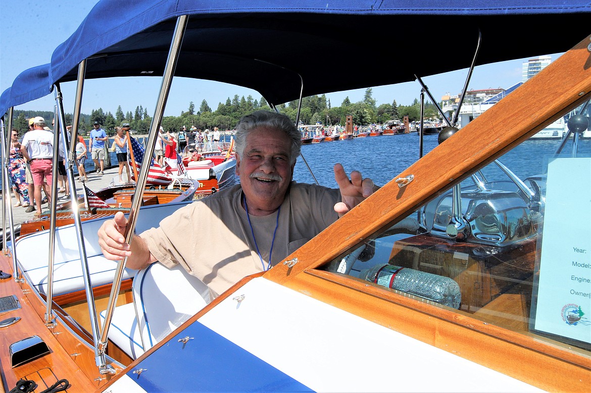 Steve Liss of Harrison looks on from his 1967 Chris-Craft during the Coeur d’Alene Antique & Classic Boat Festival on Saturday