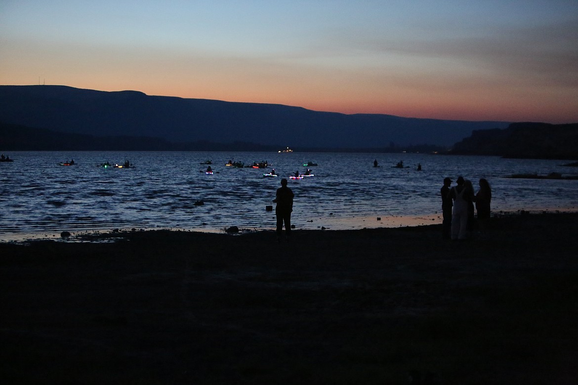 Spectators stood on the beaches of East Beach Park to watch the paddlers hit the water during sunset on Saturday.