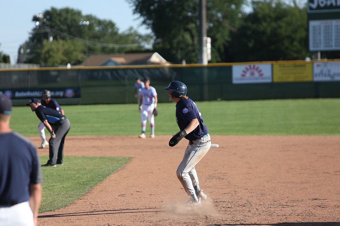 Seth Olson leads off from first base with a teammate on second base, looking to advance.