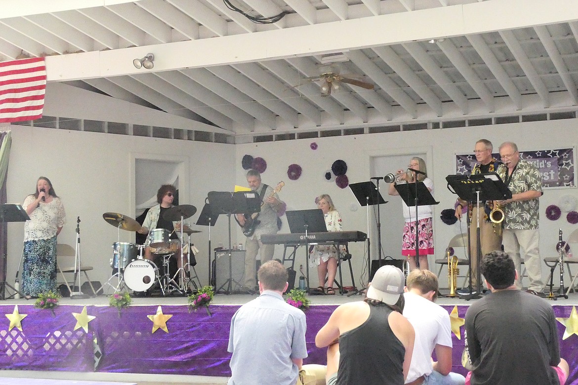 Kalispell jazz combo "Up the Creek" entertains Festival goers under the parachute roof over the main stage at Saturday Huckleberry Festival. (Chuck Bandel/VP-mi)