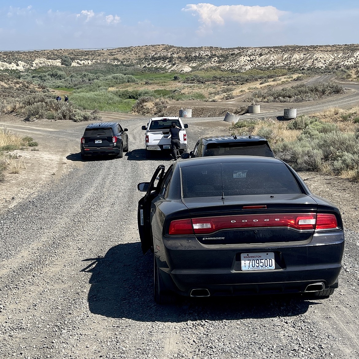 Grant County Sheriff's Office deputies as they search for the body of a missing Othello man on Friday.