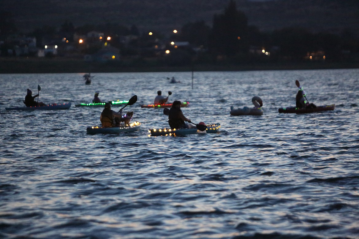 People brought their kayaks, canoes, stand-up paddleboards and inflatable rafts to Soap Lake for the Moonlight Paddle.