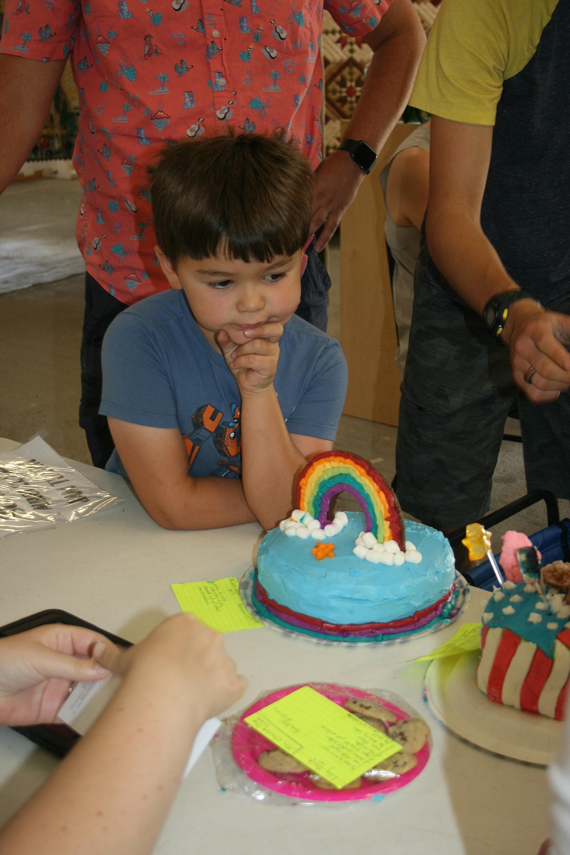 Liam Beck enters his cake in the baking division at the Grant County Fair Monday. While the fair officially opens today; competitors, volunteers and organizers were busy Monday setting everything up for visitors to enjoy.