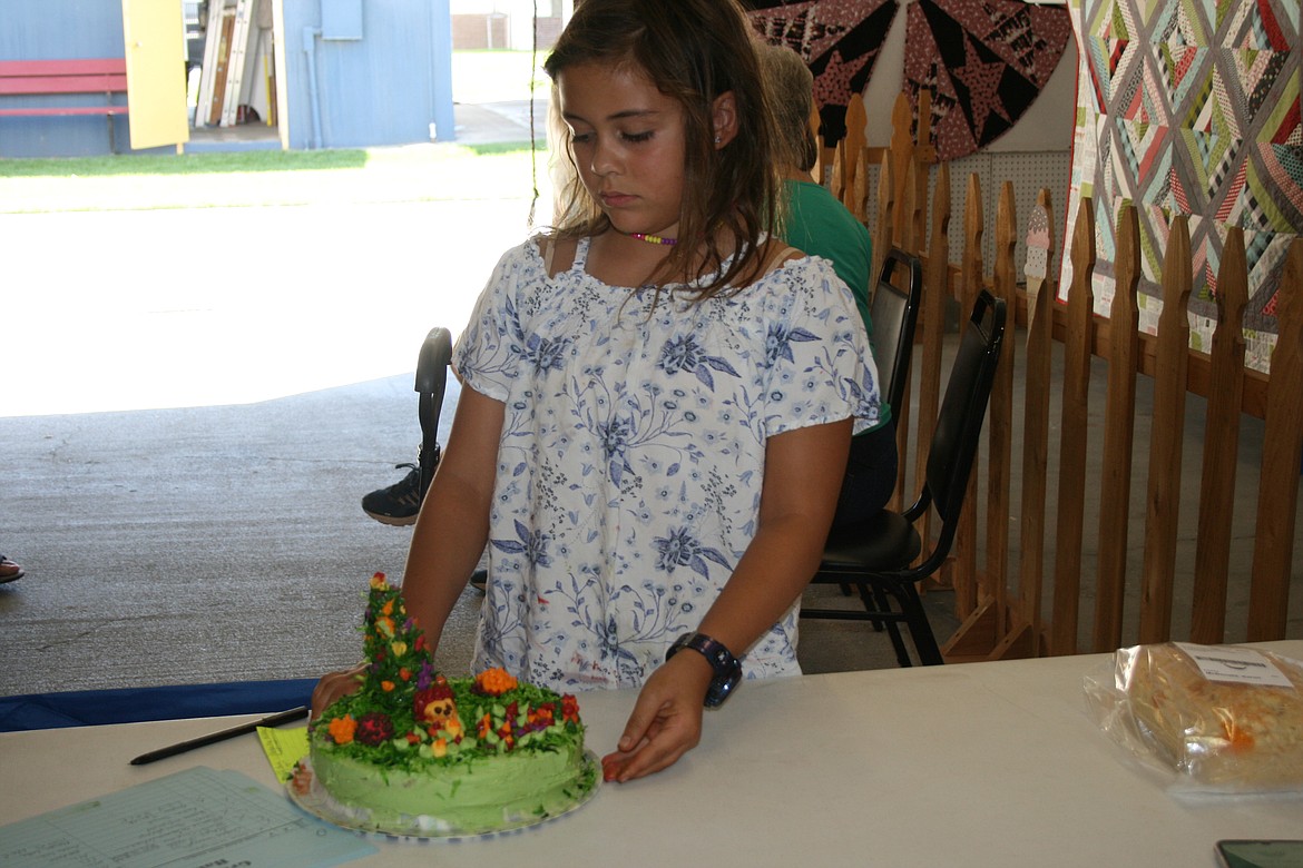 Lily Beck goes through the process of entering her cake at the Grant County Fair Monday.