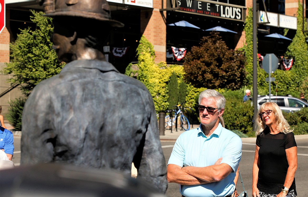 Phillips S. Baker Jr., Hecla’s president and CEO, waits to speak during the dedication of "The Miner" on Monday near McEuen Park. Mary Lee Ryba, Coeur d'Alene Arts Commission chair, stands near Baker.