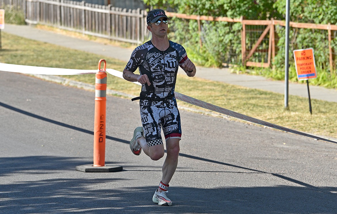 Ryan Seguine of Whitefish rounds the corner to finish in first place at the Whitefish Lake Triathlon on Sunday, Aug. 14. (Whitney England/Whitefish Pilot)