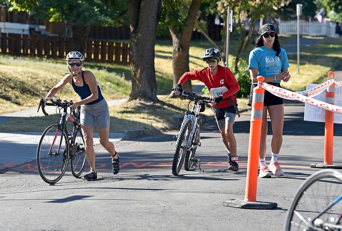 Participants make the transition from bicycling to running at the Whitefish Lake Triathlon on Sunday, Aug. 14. (Whitney England/Whitefish Pilot)