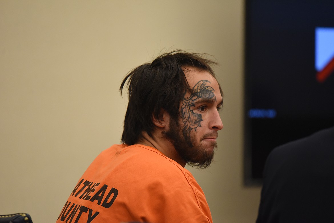 Barah Wood sits at the defendant's table during his Aug. 11, 2022, arraignment in Flathead County District Court on a felony theft charge. (Derrick Perkins/Daily Inter Lake)