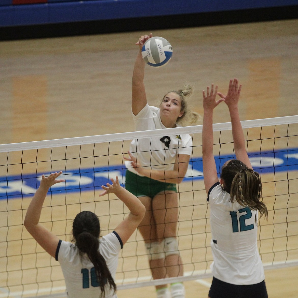 MARK NELKE/Press
Addison Raebel of Lakeland hits over Kameron Holzer (10) and Aubrey Stennett (12) of Lake City on Tuesday at a high school volleyball jamboree at Coeur d'Alene High.