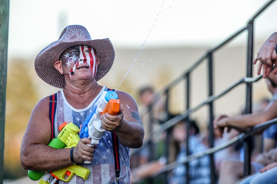 A rodeo clown helps cool down the crowd on a hot night with a squirt gun. (JP Edge photo)