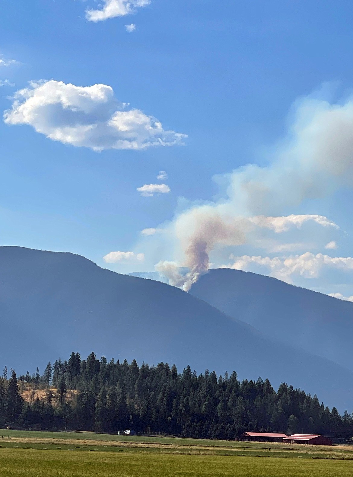 A view of the Eneas Peak Fire which can be seen from Bonners Ferry. The fire is located about 15 miles north-northwest of Bonners Ferry, on the south aspect below Eneas Peak and above Fisher Creek.