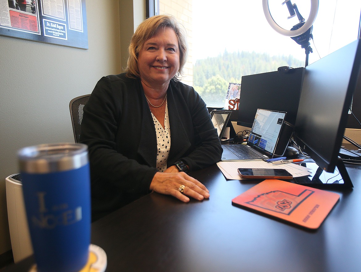 A proud Oklahoma State University graduate, Northwest Council for Computer Education CEO Heidi Rogers is celebrating 20 years with the organization. She is seen here at her desk in downtown Coeur d'Alene.