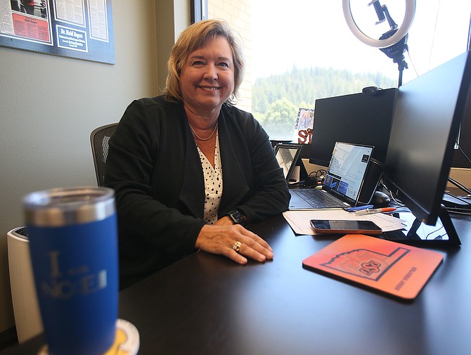 A proud Oklahoma State University graduate, Northwest Council for Computer Education CEO Heidi Rogers is celebrating 20 years with the organization. She is seen here at her desk in downtown Coeur d'Alene.