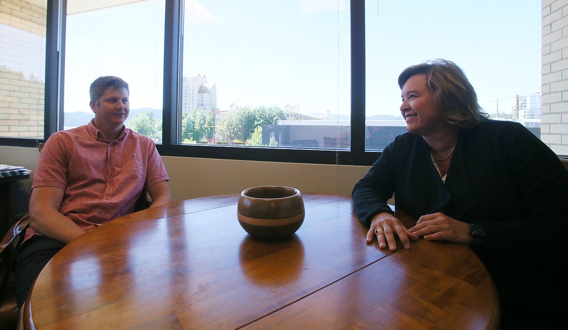 Northwest Council for Computer Education CEO Heidi Rogers chats with NCCE Director of Operations Bobby Myers in the organization's downtown office. In September, Rogers celebrates 20 years with NCCE.