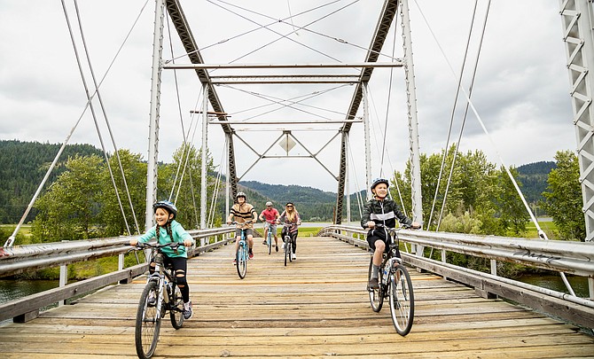 A family enjoys a bike ride along the Trail of the Coeur d’Alenes near Harrison. During its meeting at the end of July, the Idaho Travel Council granted $9,492,795 in tourism marketing funding to nonprofit organizations through the Idaho Regional Travel and Convention Grant Program.